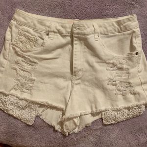 Distressed shorts with crochet pockets.